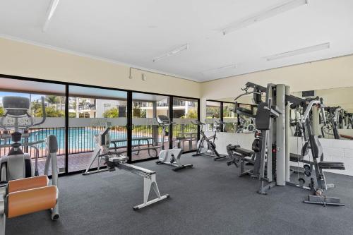 a gym with cardio equipment and a swimming pool at Marcoola Beachside Resort in Marcoola