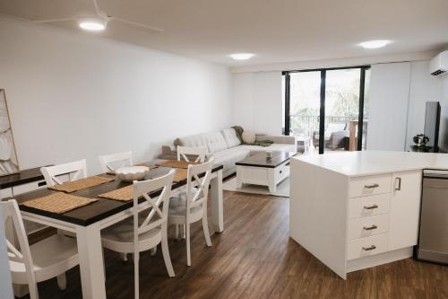 a kitchen and dining room with a table and chairs at Marcoola Beachside Resort in Marcoola