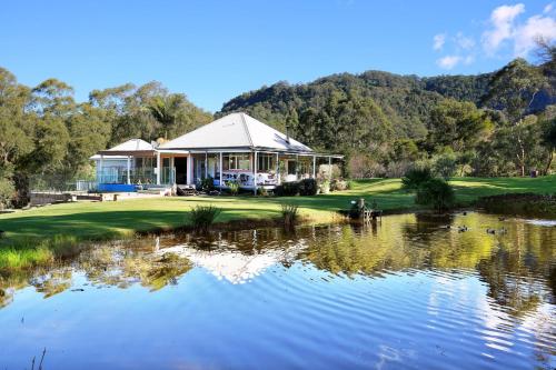 a pavilion on a golf course next to a pond at Kiah - By Berry Getaways in Berry
