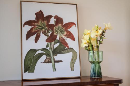 a picture of flowers in a vase on a table at Meroo Springs - By Berry Getaways in Meroo
