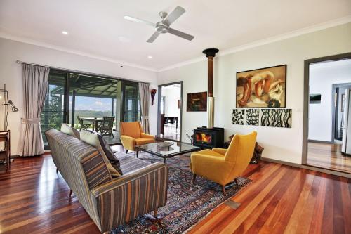 a living room with a couch and chairs and a fireplace at Borrowdale - By Berry Getaways in Berry