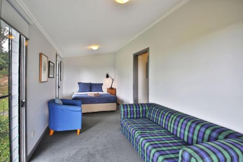 a living room with a couch and a bed at Borrowdale - By Berry Getaways in Berry