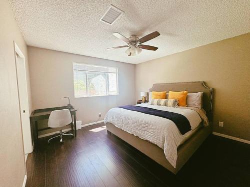 a bedroom with a bed and a ceiling fan at Spacious & Immaculate Haven near Downtown SD in San Diego