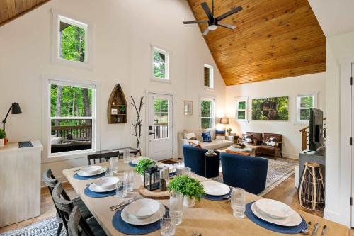 a dining room and living room with a table and chairs at White Pines Lodge- Wooded Retreat in Cub Run