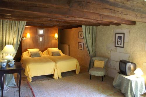 En eller flere senge i et værelse på Le Clos de Ligré