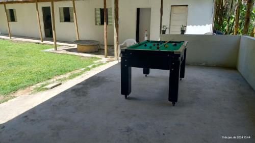 a ping pong table sitting in a yard at ESPAÇO ShEHERAZADE PISCINA & LAZER in Juquitiba
