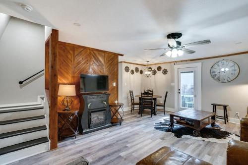 a living room with a fireplace and a table at Pet-Friendly Granbury Home with Yard, Near Downtown! in Granbury