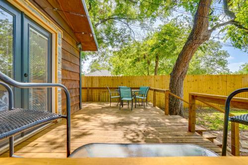 a deck with chairs and a table and a tree at Pet-Friendly Granbury Home with Yard, Near Downtown! in Granbury