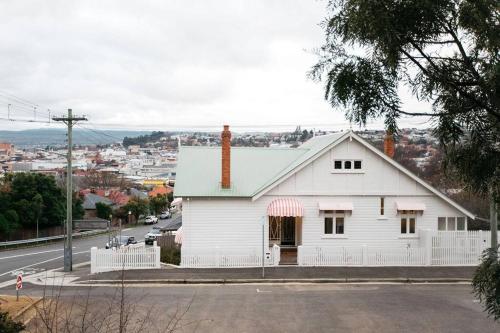 a white house on the side of a street at Harmony House - CBD in Launceston