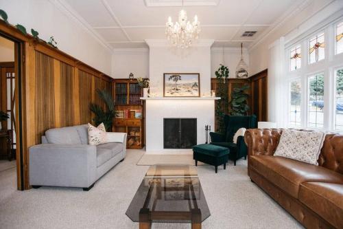 a living room with a couch and a fireplace at Harmony House - CBD in Launceston