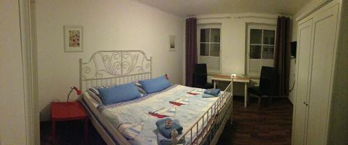 a bedroom with a bed with a teddy bear on it at Pension da Luigi in Greifswald