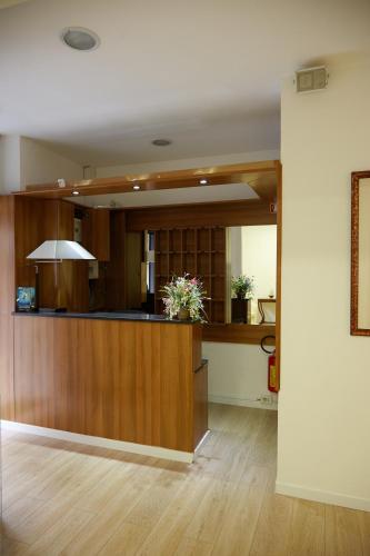 a living room with a counter with flowers on it at Hotel Lydia in Alassio