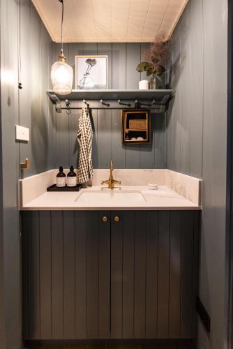 a bathroom with a sink and a counter at Mabel's Cottage - By Berry Getaways in Berry