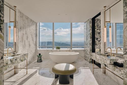 a bathroom with a tub and a large window at Park Hyatt Changsha in Changsha
