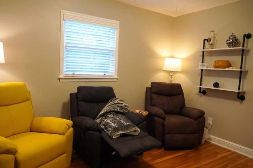 a living room with two chairs and a couch at Spacious Pet Friendly Home in Martinsville