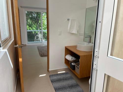 a bathroom with a sink and a mirror at Casa Joya - Luxury 3 Bed 4 Bath Home with View - Puntarena in Puerto Morelos