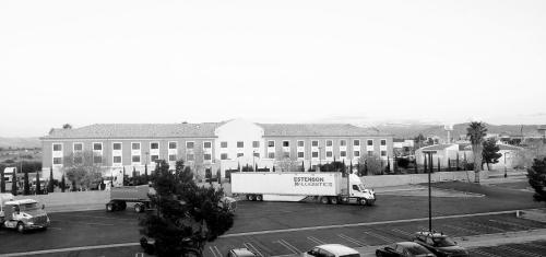 a truck in a parking lot in front of a large building at Studio 6 Suites Hesperia, CA West Main Street I 15 in Hesperia