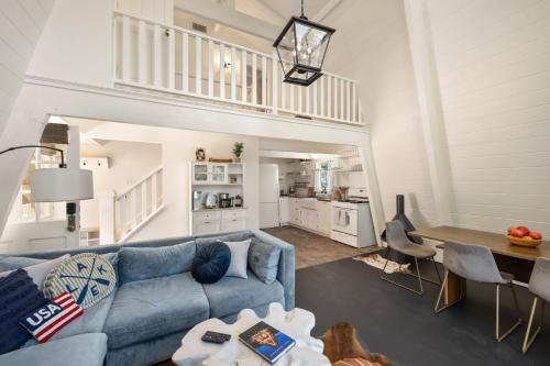 a living room with a blue couch and a table at Scout's Lakehouse Retreat by Colby & Conrad in Lake Arrowhead