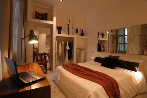 a bedroom with a bed and a laptop on a desk at Isola Libera in Milan