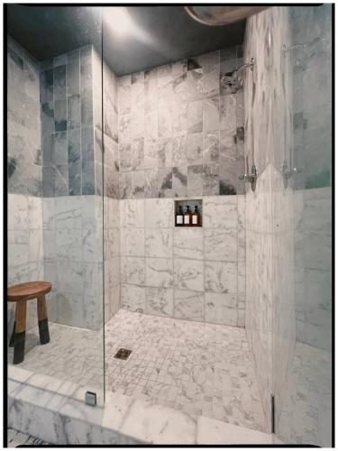 a bathroom with a shower with a glass door at Thames Home in Taylor