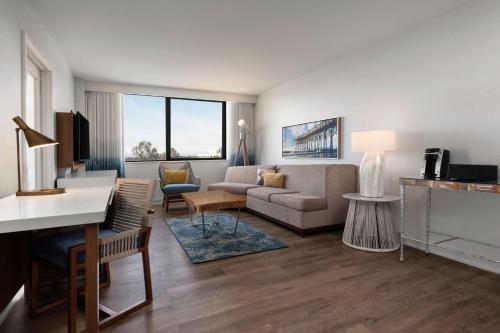 a living room with a couch and a table at Renaissance Newport Beach Hotel in Newport Beach