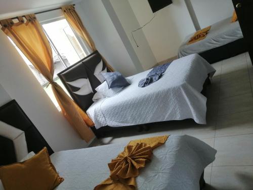 Postel nebo postele na pokoji v ubytování Hotel Linaje Popayán