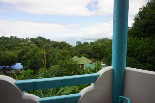 a view of the ocean from a resort balcony at Hotel Planeta Sano in Manuel Antonio