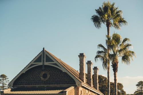 a building with a palm tree in the background at The Sebel Kiama in Kiama
