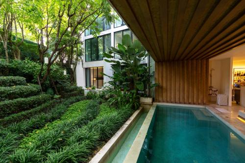 a swimming pool in the middle of a building at K Maison Lanna Boutique Hotel-SHA Plus Certified in Chiang Mai
