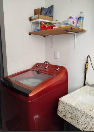 a red tv in a room with a shelf at Alojamiento entero in Mexico City