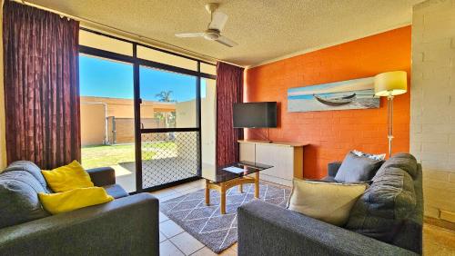 a living room with two couches and a television at Riverview Holiday Apartment 49 - Kalbarri WA in Kalbarri