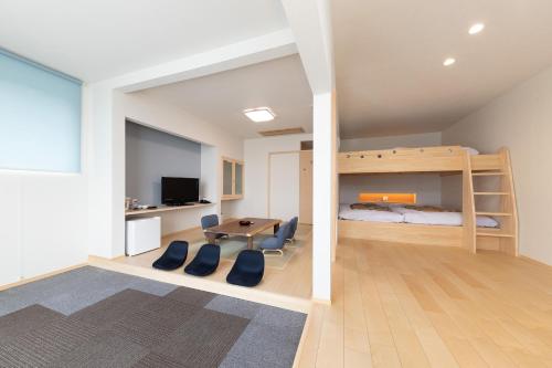 a bedroom with a bunk bed and a table and chairs at Bosenkan in Gero