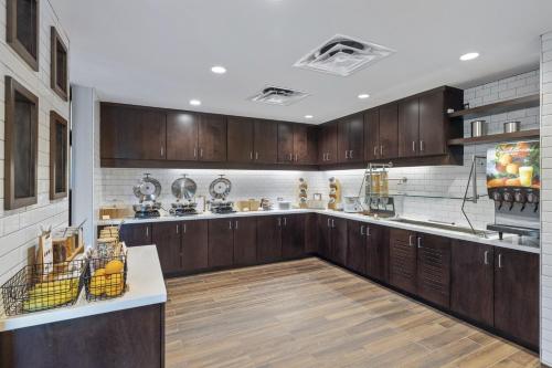 a large kitchen with wooden cabinets and wooden floors at Residence Inn by Marriott Lodi Stockton in Lodi