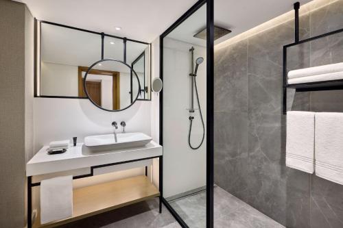 a bathroom with a sink and a mirror at Sheraton Cairo Hotel & Casino in Cairo