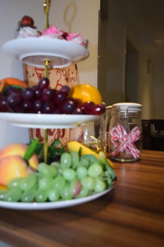 a plate of fruit on top of a table at Lucky 8 Hotel in Ilford