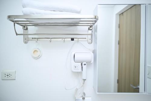 a bathroom with a mirror and a towel rack at Anne's Place at Hope Residences - SMDC Condo Beside SM Trece in Trece Martires