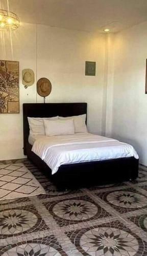 a bedroom with a bed in a room at exclusive VILLA cel in Batangas City