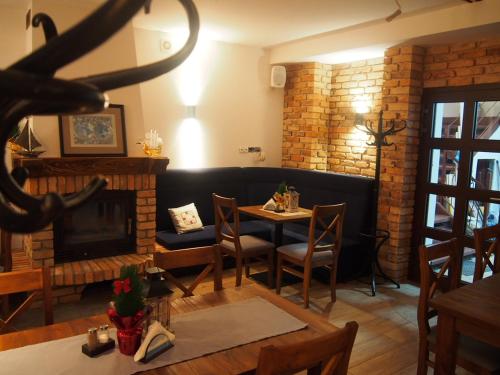a living room with a table and a fireplace at Tawerna Panorama in Stepnica
