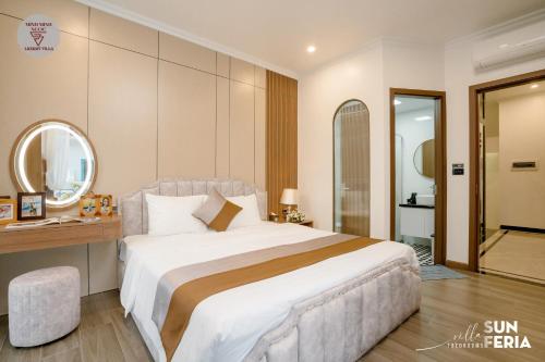 a bedroom with a large white bed and a mirror at Sun Villa 7 br & pool in Ha Long