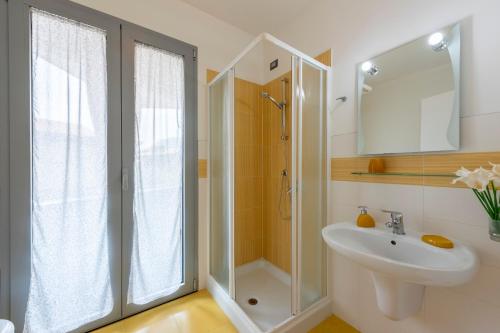 a bathroom with a shower and a sink at Rosy & Onyx House With Shared Pool in Toscolano Maderno