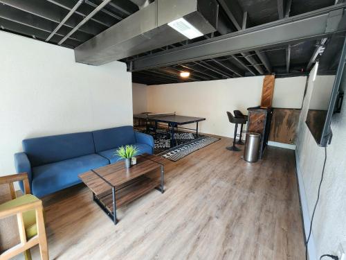 a living room with a blue couch and a table at Newly Renovated 3 Bedroom St. Peters MO Home in Cottleville