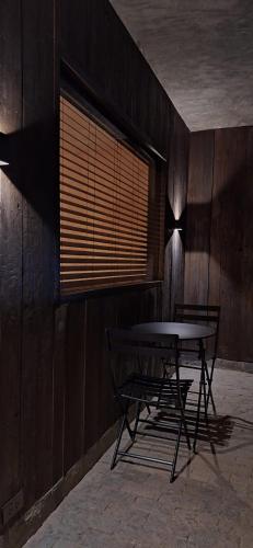 a table and chairs in a room with a window at The Rover Siargao - Loft in General Luna