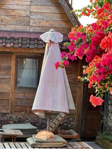 a umbrella sitting on a table in front of a house at PINOKKIO B&B Restaurant in Jimbaran