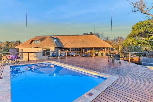 a house with a swimming pool on a deck at Thula-Thula Private Game Lodge Mabalingwe in Bela-Bela