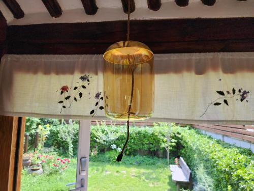 a chandelier hanging from a window with butterflies on the curtain at Jahayeon Hanokstay in Jeonju