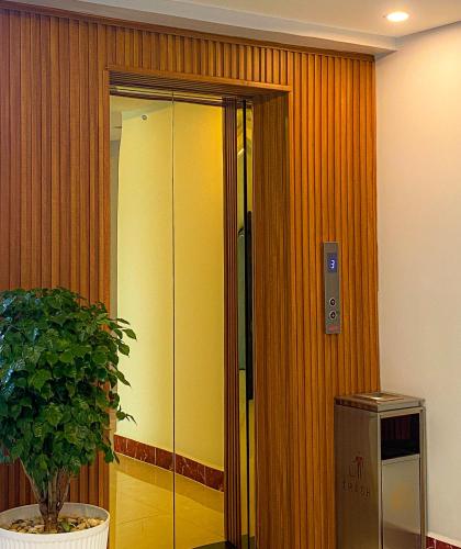 a glass door in a room with a potted plant at Keang You Boutique Hotel in Phnom Penh