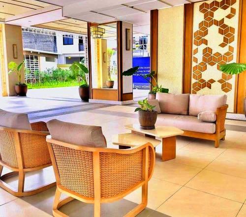 a living room with a couch and a table at Cuddle & Cradle Staycation at The Celandine in Manila