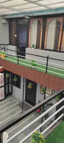 a balcony of a building with potted plants on it at Sukh Sagar Hotel in Jaipur