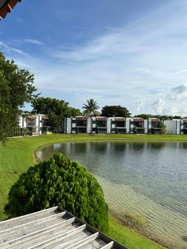 a view of a lake with houses in the background at Beautiful apartment with very elegant colonial decoration in Tamiami