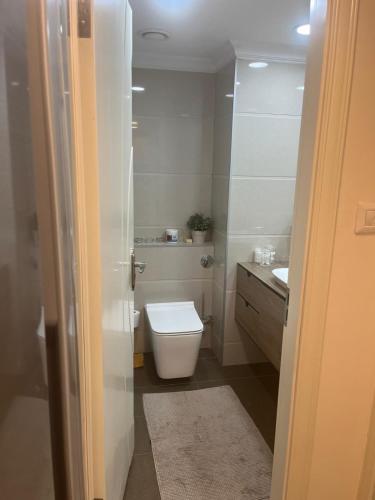 a bathroom with a toilet and a sink at Mount Dreams in Shoresh